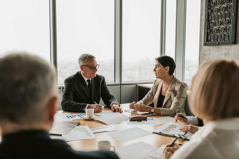 Business professionals engaged in a strategic meeting in a modern office setting